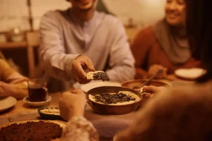 People breaking bread symbolizing Arabic expressions inspired by food and eating